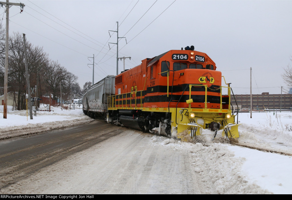Its orange paint standing out from the snowy and bleak landscape, GR 2104 rolls west on former GTW rails